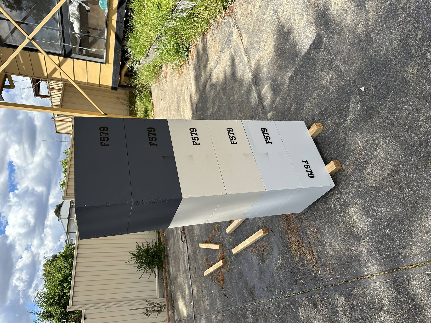 Freshly built and painted beehive boxes stacked outdoors